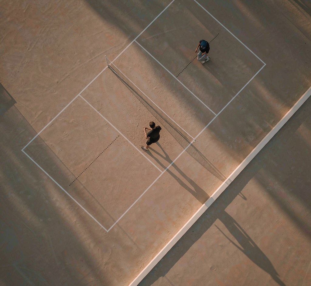 Aerial view of a pickleball court in late afternoon light
