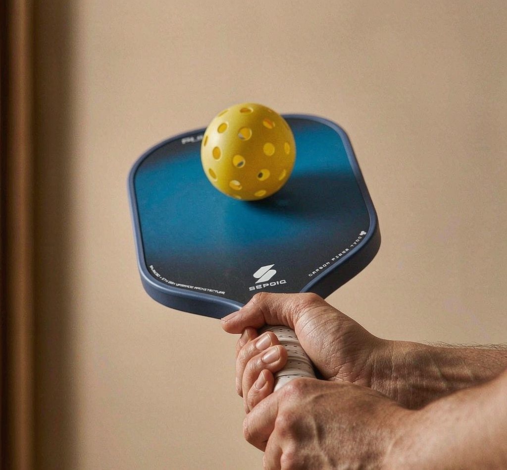 Close-up of a paddle striking a pickleball